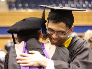 a student embracing a professor