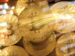 Blurred photo of gold coins with Bitcoin logo on them
