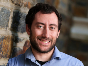 Michael Dinnerstein leaning against stone wall