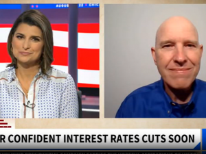 Video still of news reporter and Connel Fullenkamp with chyron that reads "Fed Chair Confident Interest Rates Cut Soon"