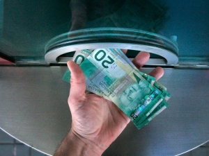 A hand holding bills