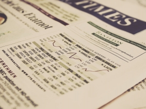 A newspaper showing stock graphs