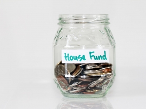 mason jar filled with coins labeled "house fund"