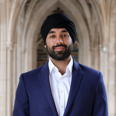 Arjun Bakshi headshot with Duke Chapel arches in the background