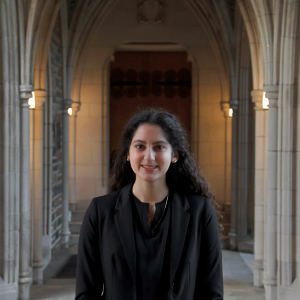 Portrait photo of Clare Abboud with Duke Chapel arches in the background